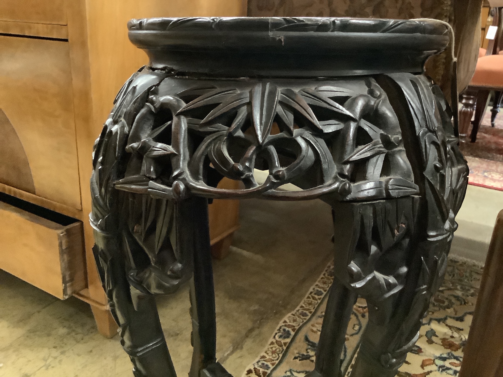 A Chinese carved hardwood marble top vase stand